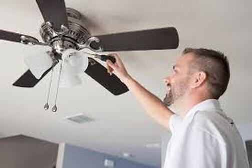 Electrician fixing ceiling fan