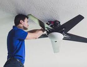 Electricians installing ceiling fan